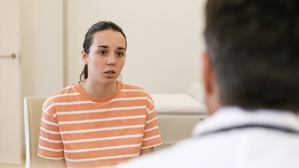 Concerned woman talking to doctor